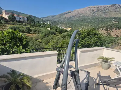 a chair on a balcony with a view of a mountain at Panoramica Via Villa in Carini