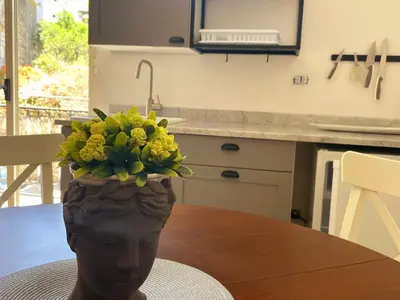 a vase with yellow flowers on top of a table at Panoramica Via Villa in Carini