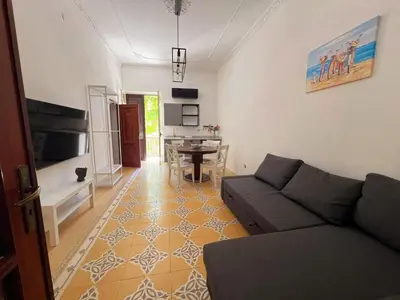 a living room with a couch and a table at Panoramica Via Villa in Carini