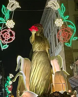a statue of a woman holding a red flower at La casetta di gra in Palermo
