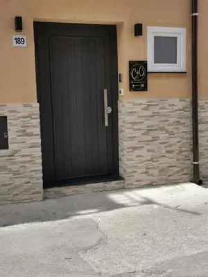 a black door on the side of a building at La casetta di gra in Palermo