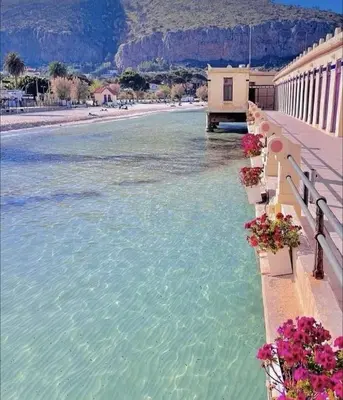 a view of a body of water with buildings and flowers at La casetta di gra in Palermo