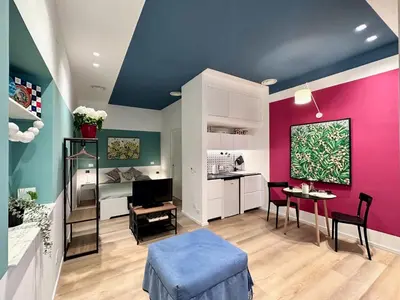 a living room with pink and green walls at La Nica in Palermo