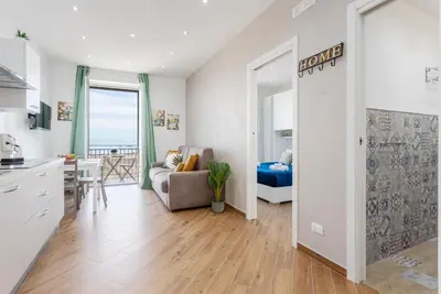 a kitchen and living room with a couch and a table at Sant'Erasmo luxury home in Palermo