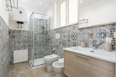 a bathroom with a shower and a toilet and a sink at Sant'Erasmo luxury home in Palermo