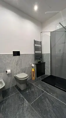a bathroom with a toilet and a shower at A Casuzza in Palermo
