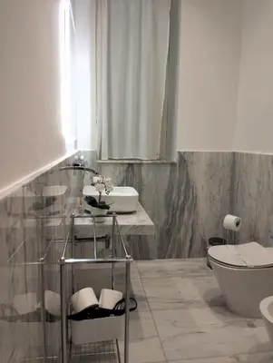 a bathroom with a sink and a toilet at Lily Suite 10 in Palermo