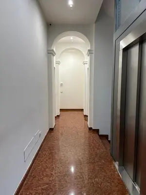 a hallway with white walls and an archway and a hallway with a door at Lily Suite 10 in Palermo