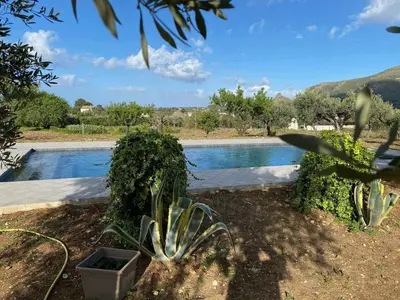 a garden with a swimming pool in the background at VILLA AZUL in Castellammare del Golfo