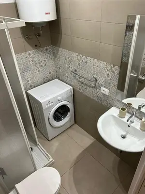 a bathroom with a washing machine and a sink at La Cupola - casa vacanze n 10 in Termini Imerese