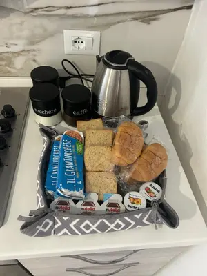 a refrigerator with a tray of food and a tea kettle at La Cupola - casa vacanze n 10 in Termini Imerese