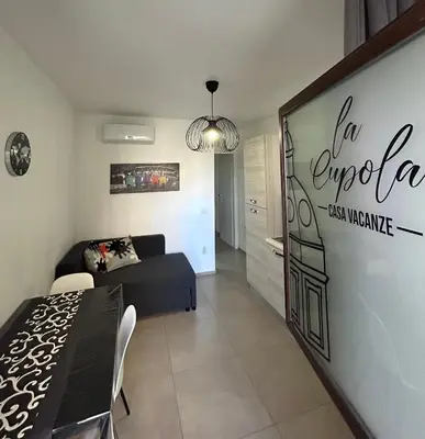 a living room with a black table and a couch at La Cupola - casa vacanze n 10 in Termini Imerese