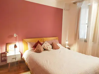 a bedroom with a bed with a red wall at Casa Anita In centro in Palermo