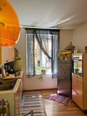 a kitchen with a refrigerator and a window at Casa Anita In centro in Palermo
