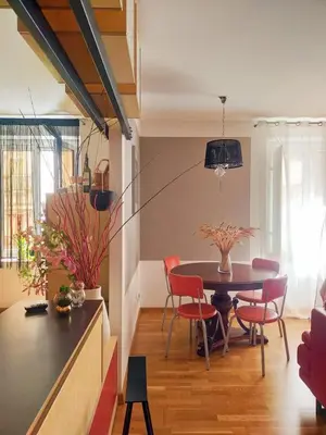 a dining room with a table and red chairs at Casa Anita In centro in Palermo
