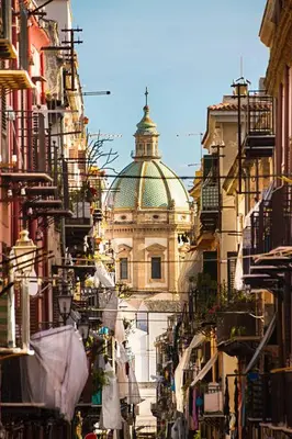 a building with a dome on top of a street at Casa Anita In centro in Palermo
