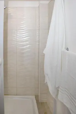 a bathroom with a shower and a white tub at LA CASA DELL'EMIRO in Misilmeri