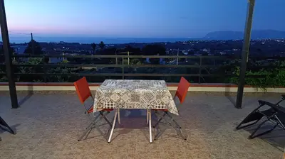 a table and chairs on a balcony with a view at La Terrazza Bella Vista in Castellammare del Golfo