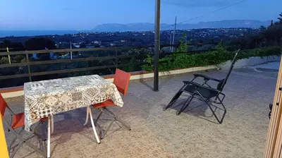 a table and chairs on a balcony with a view at La Terrazza Bella Vista in Castellammare del Golfo