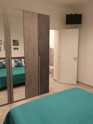 a bedroom with sliding glass doors and a bed at Nora’s Home in Palermo