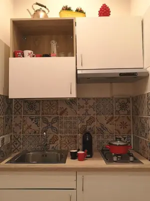 a kitchen with a sink and a counter top at Nora’s Home in Palermo