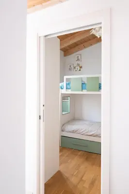 a small bedroom with a bunk bed in it at La Cecia Home in Castellammare del Golfo