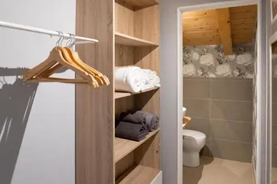 a bathroom with a toilet and a closet with towels at La Cecia Home in Castellammare del Golfo