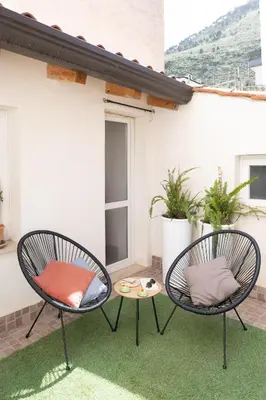 two chairs and a table on a patio at La Cecia Home in Castellammare del Golfo