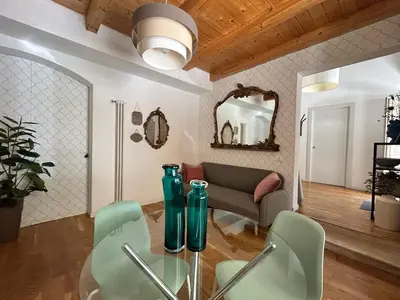 a living room with a couch and a glass table at La Cecia Home in Castellammare del Golfo