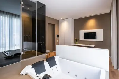 a bathroom with a white sink and a mirror at Amorgiù Luxury Suites in Palermo