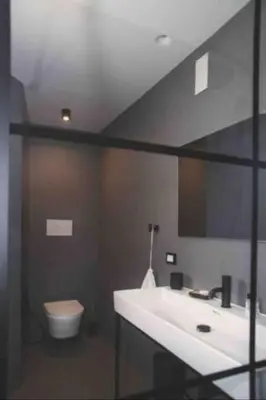 a bathroom with a white sink and a toilet at Villa delle Sterlizie con piscina e jacuzzi by Le Dhome Sicily in Partinico