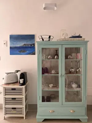 a blue cabinet with glass doors next to a dresser at Chalet Tango in Contrada Sauci Grande