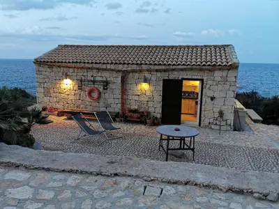 a small stone building with a table and a table sidx sidx sidxktopktop at Chalet Tango in Contrada Sauci Grande