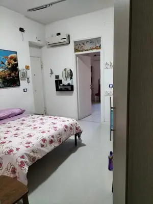 a bedroom with a bed with a floral comforter at Ciuridda mia in Palermo