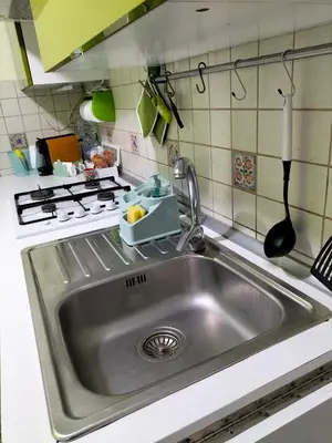 a kitchen sink with a utensil next to a stove at Ciuridda mia in Palermo