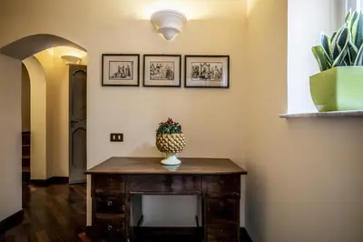 a vase on a table in a hallway with pictures on the wall at la Kalsa 14 nel centro storico di Palermo in Palermo