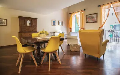 a dining room with a table and yellow chairs at la Kalsa 14 nel centro storico di Palermo in Palermo