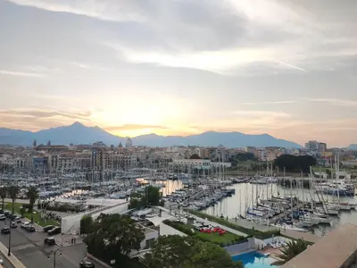 a view of a city with boats in a marina at Maison al-Aziz in Palermo