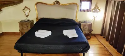 a bedroom with a bed with two pillows on it at Maison al-Aziz in Palermo