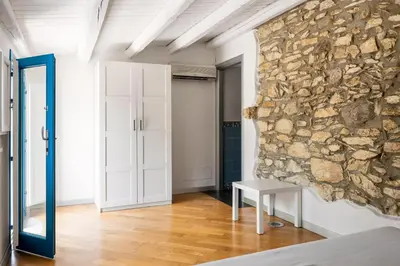 a room with a stone wall and a table at Villa Celeste in Castellammare del Golfo