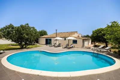 a large swimming pool in front of a house at Villa Celeste in Castellammare del Golfo