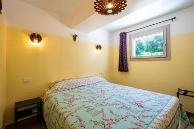 a bedroom with a bed and a window at Villa Maguetta with private pool in Scopello in Scopello