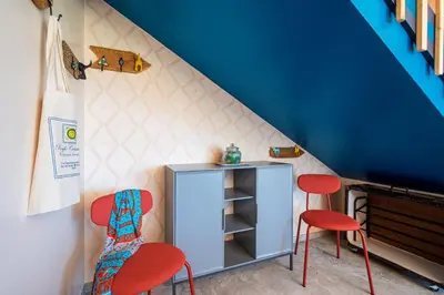a room with two chairs and a cabinet under a staircase at Villa Maguetta with private pool in Scopello in Scopello