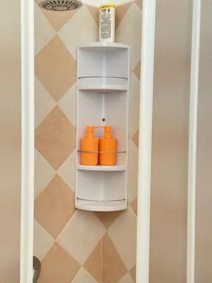 a small white refrigerator with orange objects in it at Luna Marina - Sicilian beach house in Santa Flavia