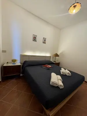 a bedroom with a bed with two towels on it at Luna Marina - Sicilian beach house in Santa Flavia