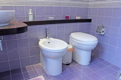 a bathroom with a toilet and a sink at La Favorita - Ben collegato con l'aeroporto, la spiaggia di Mondello e il centro città in Palermo