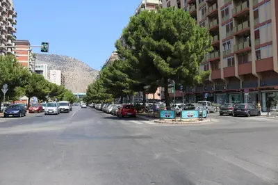 a street with cars parked on the side of the road at La Favorita - Ben collegato con l'aeroporto, la spiaggia di Mondello e il centro città in Palermo