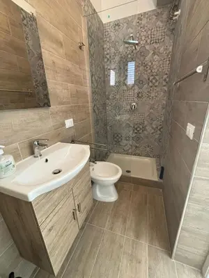a bathroom with a sink and a toilet and a shower at Fauka blu in Carini