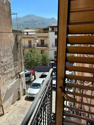 a balcony with a car parked on a street at Fauka blu in Carini