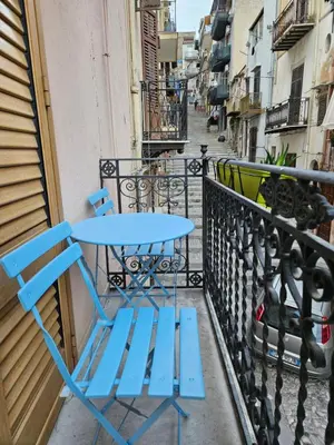 a blue table and chair on a balcony at Fauka blu in Carini
